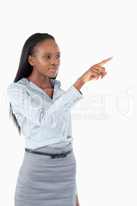 Portrait of a young businesswoman pressing an invisible key