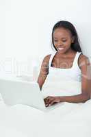 Portrait of a woman using a laptop before sleeping