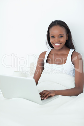 Portrait of a woman using a notebook before sleeping