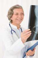 Senior doctor female smiling hold x-ray