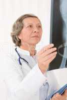 Senior doctor female looking at x-ray