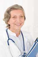Senior doctor female hold folders smiling