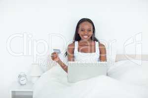 Smiling woman booking her holidays online