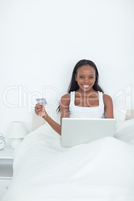 Portrait of a smiling woman booking her holidays online