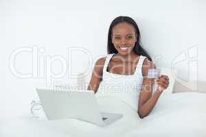 Cute woman booking her holidays online