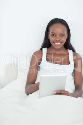 Portrait of a smiling woman using a tablet computer