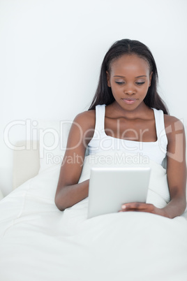 Portrait of a calm woman using a tablet computer