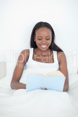 Portrait of a young woman reading a book