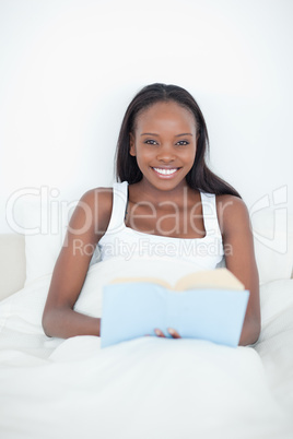 Portrait of a young woman holding a book