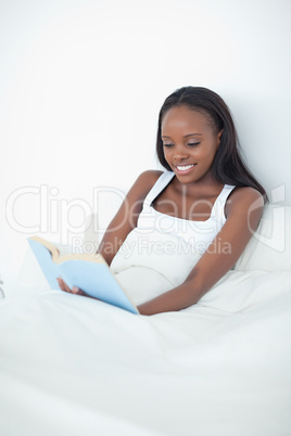 Portrait of a happy woman reading a book