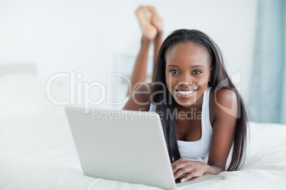 Woman lying on her belly with a laptop
