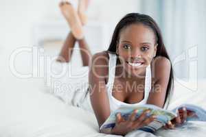 Smiling woman holding a magazine