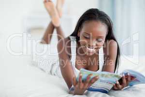 Smiling woman reading a magazine