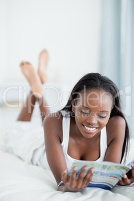 Portrait of a smiling woman reading a magazine