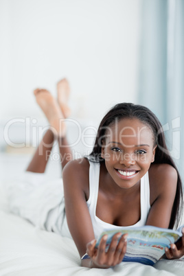 Portrait of a happy woman reading a magazine