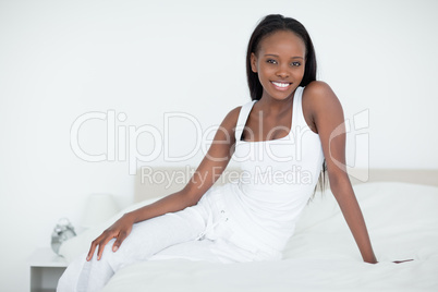 Woman posing on her bed