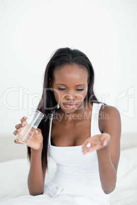 Portrait of a sick looking at pills