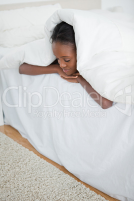 Portrait of a woman sleeping under her duvet