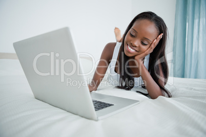 Young woman watching a movie on her notebook