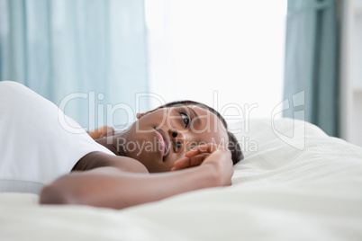 Thoughtful woman lying on her back