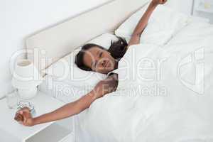 Woman stretching her arms while waking up