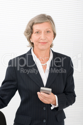 Senior businesswoman smile hold cellphone