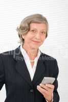 Senior businesswoman smile hold cellphone