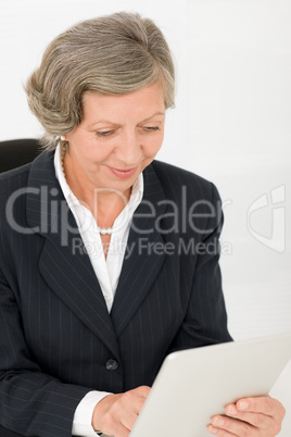 Senior businesswoman touch-screen tablet computer