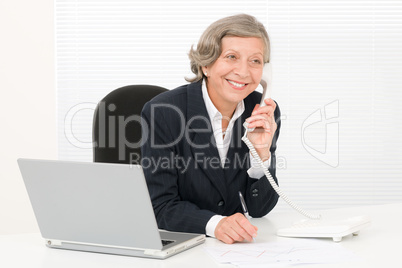 Senior businesswoman smile sit behind office desk