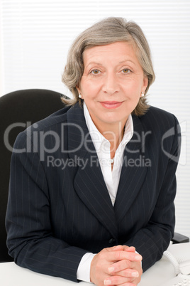 Senior businesswoman professional behind table