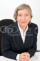 Senior businesswoman professional behind table