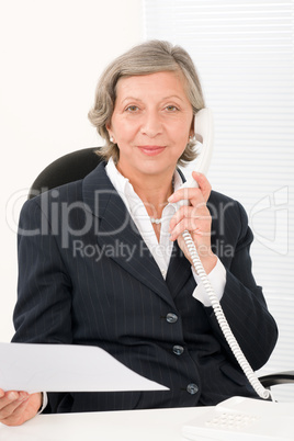 Senior businesswoman on phone hold empty sheet