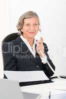 Senior businesswoman on phone hold empty sheet