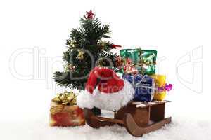 Schlitten und Geschenke unterm Weihnachtsbaum