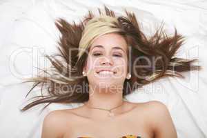 Woman lying in bed smiling