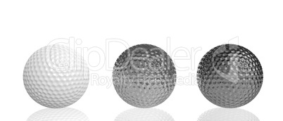 three golf balls of different materials