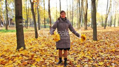 Woman Rotates With Leaves