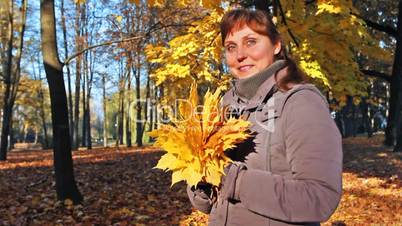 Woman Stands With Leaves