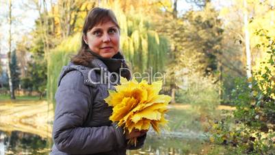 Woman Sits And Holds Leaves