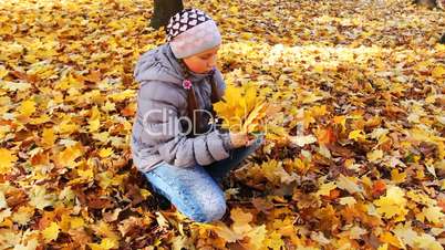 Girl Sits And Holds Leaves
