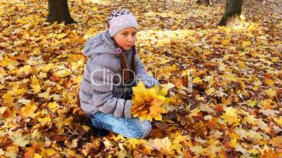Girl Holds And Tosses Up Leaves