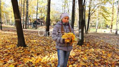 Girl Stands And Tosses Up Leaves