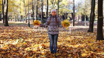 Girl Rotates And Scatters Leaves
