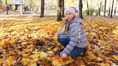 Girl Collects Falling Leaves