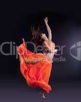 yong girl dance and jump in orange costume