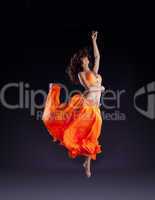 beauty dancer jump in orange veil - arabian style