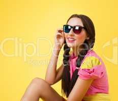 Funny woman in doll dress look in stereo glasses