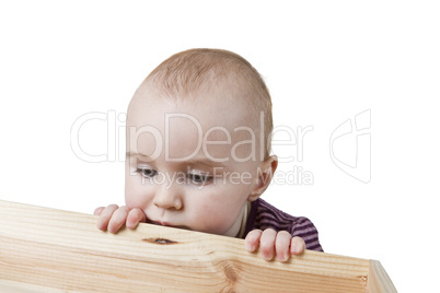 baby looking into wooden box