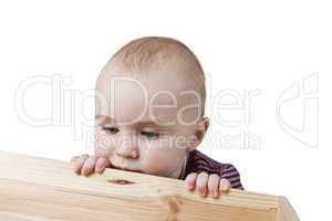 baby looking into wooden box