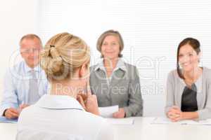 Job interview young woman with business team